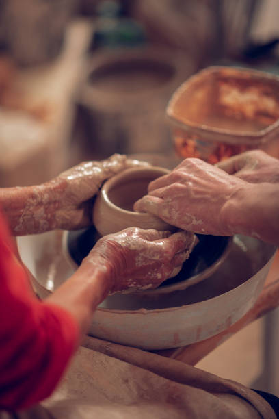 istock Close up of human hands molding the pot 1149879069