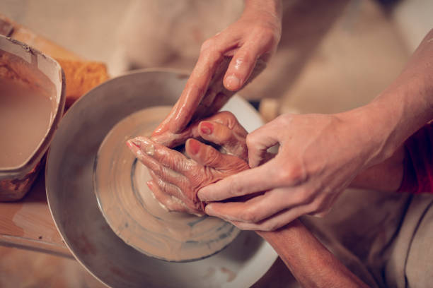 istock Top view of female hands in clay 1149879086
