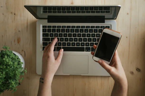 Laptop and smartphone on a white background. Close-up.