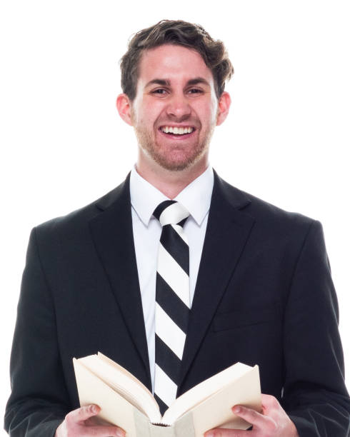 istock Good looking young businessman wearing black suit - holding book 1149880218