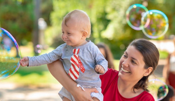 istock Cute Baby Catching Soap Bubbles 1149881746