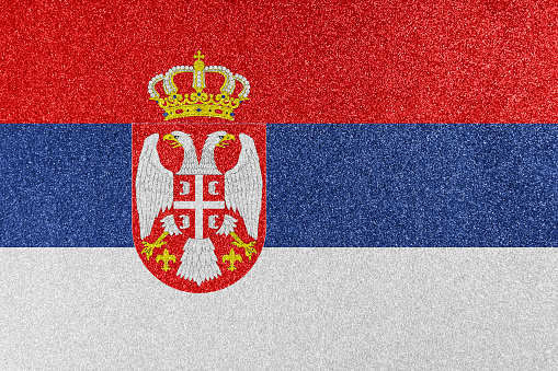 Serbian national flag on glitter texture.