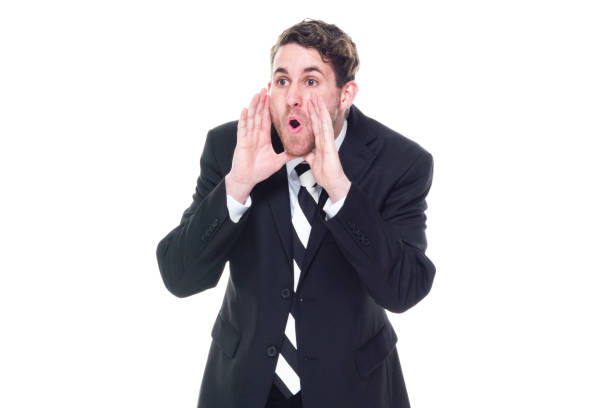 istock Good looking young businessman standing on white background - shouting 1149882856