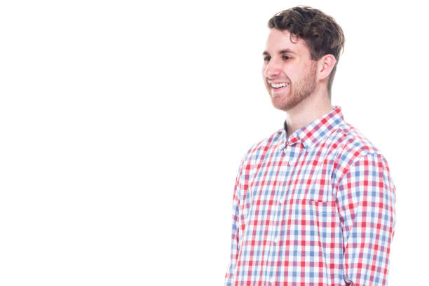 istock Attractive young man wearing a checked shirt and jeans - hands by side 1149884373