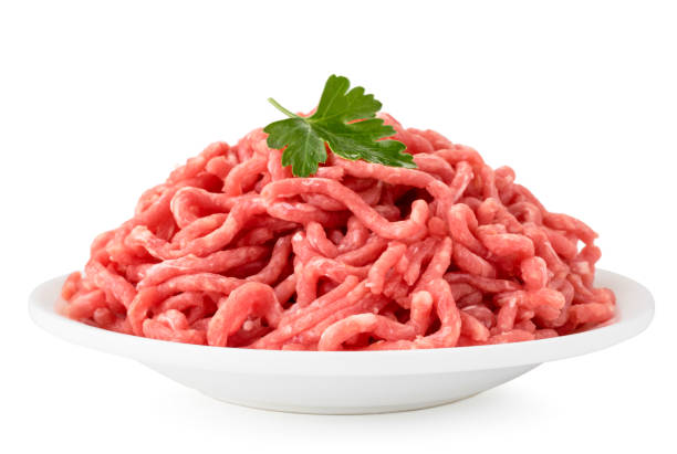 minced meat with parsley leaves in a plate on a white, isolated. - meat grinder ground beef meat imagens e fotografias de stock