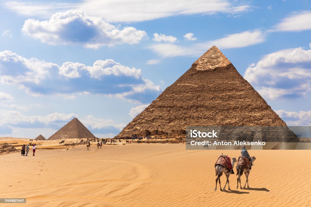 The Pyramids and bedouins in the desert of Giza, Egypt The Pyramids and bedouins in the desert of Giza, Egypt. Egypt Stock Photo