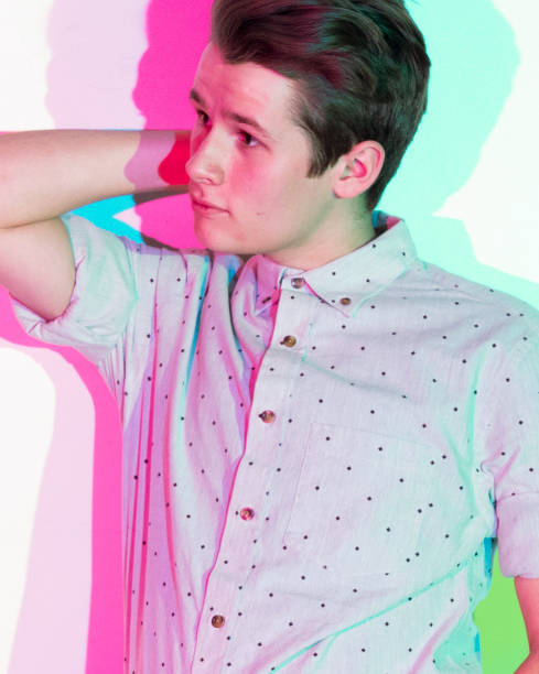 istock Handsome young man standing against white wall with colorful shadows 1149888626