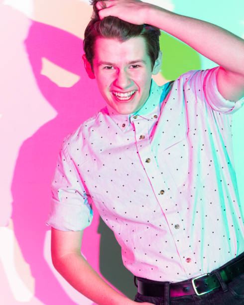 istock Handsome young man standing against white wall with colorful shadows 1149888715