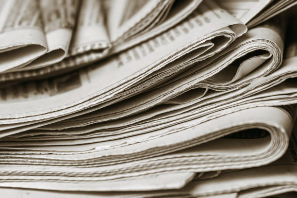 istock News concept, folded newspaper closeup. 1149889673