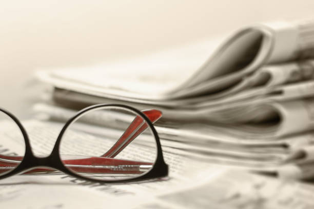 istock Newspapers on the desktop, eyeglasses. News concept 1149889721