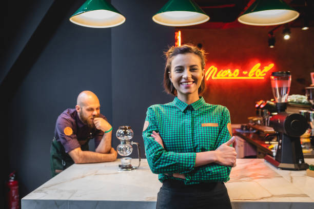 istock Beautiful female cafe waitress posing for a picture while in her favorite workplace 1149890266