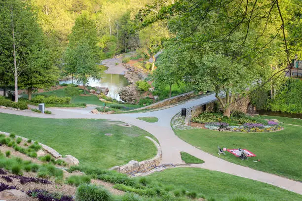 Photo of View from above of amazing Greenville Falls park with picnic blanket on a green grass