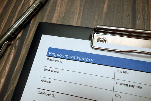 Clipboard with employment history document, job application form
