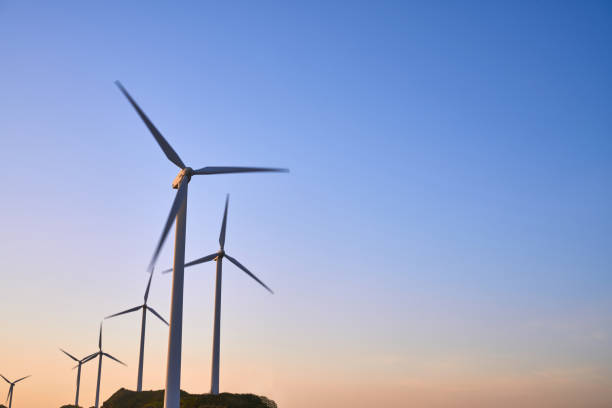 istock Wind turbines on hilltops against the setting sun 1149891868