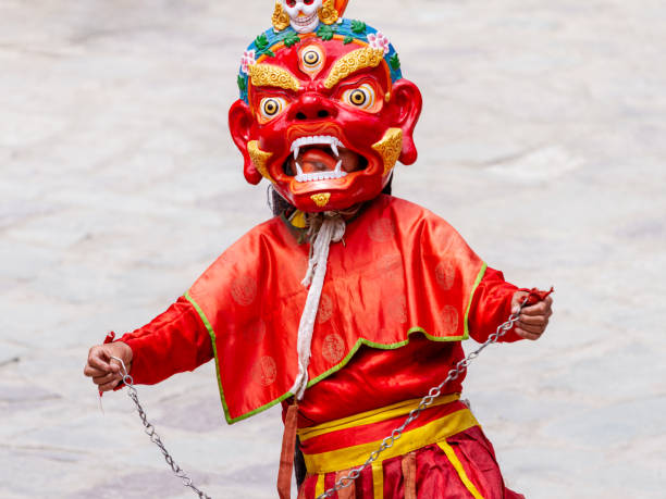 la cadena de acero monje no identificada en la máscara dharmapala lleva a cabo una danza religiosa enmascarada y disfrazado de misterio del budismo tibetano tántrico en el festival de danza cham en el monasterio de hemis - cham mask fotografías e imágenes de stock