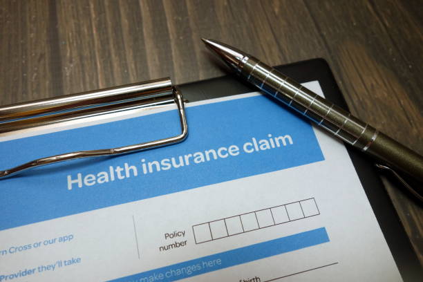 istock Health insurance claim form with pen on desk 1149895149