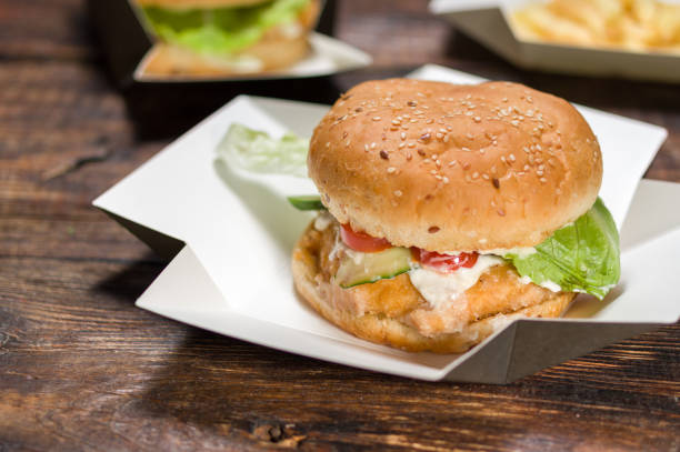 istock White wheat burger. Burger close up. Burger sprinkled with seeds. 1149895308