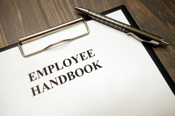 istock Clipboard with employee handbook and pen on desk 1149896134