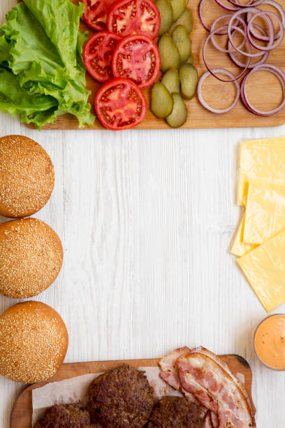 istock Cheese burger ingredients on a white wooden background, top view. From above, overhead, flat lay. Copy space. 1149897796
