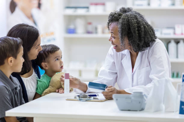 istock Pharmacist helps a mid adult mother 1149898836