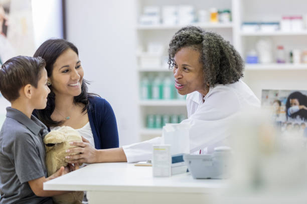 istock Caring mature pharmacist talks with young boy 1149898858