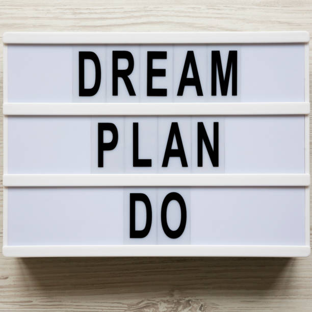 istock Modern board with text 'Dream plan do' over white wooden surface, top view. Business concept. From above, flat-lay, overhead. 1149900962