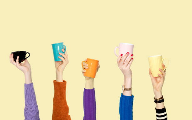 istock Many different arms raised up holding coffee cup 1149904545