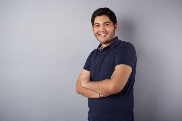 istock Young smiling man with crossed arms 1149906348