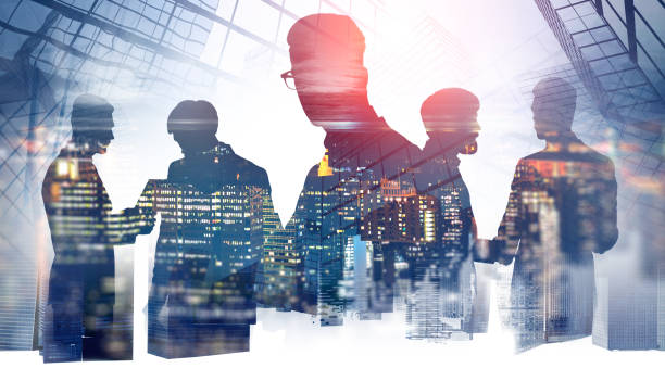istock Business people collaborating, night skyscrapers 1149906647