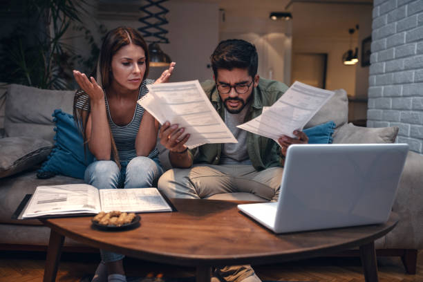 istock Worried young couple with financial bills 1149907828