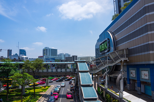 Bangkok, Thailand, March 2013 MBK shopping center, traffic jam near mall, sunny hot day with blue skies