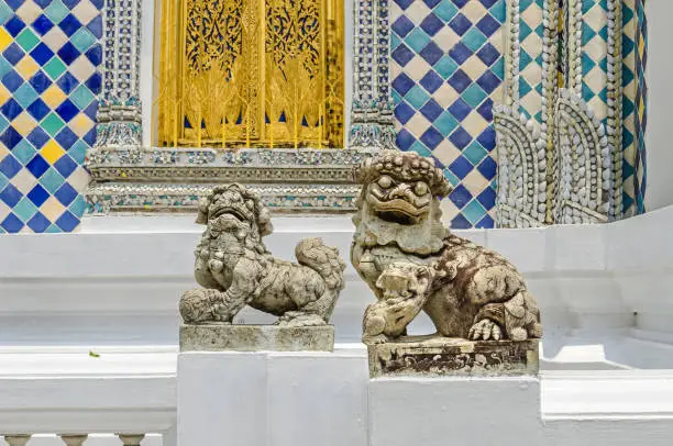 Photo of Chinese guardian lions at the entrance of one of the buildings within the Grand Palace in Bangkok, Thailand