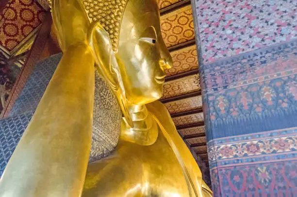 Photo of Reclining Buddha  in a Buddhist temple complex Wat Pho in Bangkok