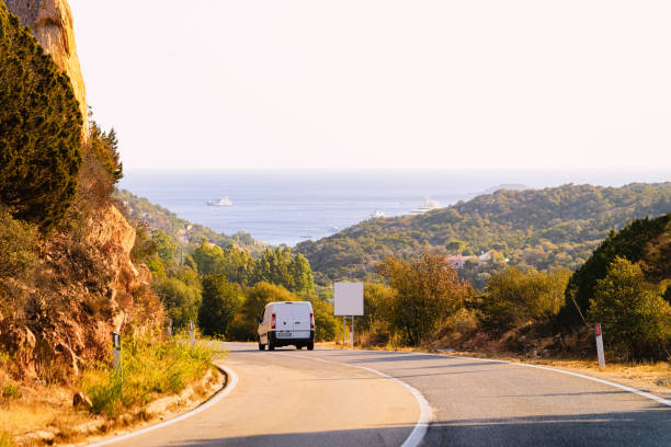 istock Mini van on road in street in Sardinia 1149910130