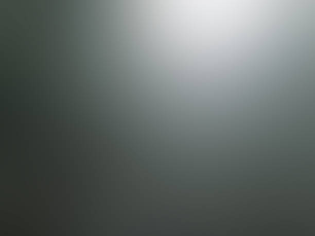 istock Abstract monochrome background with different gray colors and a well lit spot 1149912812