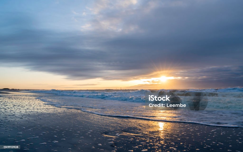Dramatic sunrise over Jersey Shore Beautiful sunrise over Long Beach Island, New Jersey featuring gorgeous waves and reflection on the foreground and dramatic sky on the background Long Beach Island Stock Photo