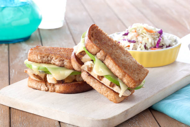 Chicken Apple Sandwich roasted chicken and apple sandwich on wheat bread with coleslaw side sandwich healthy lifestyle healthy eating bread stock pictures, royalty-free photos & images
