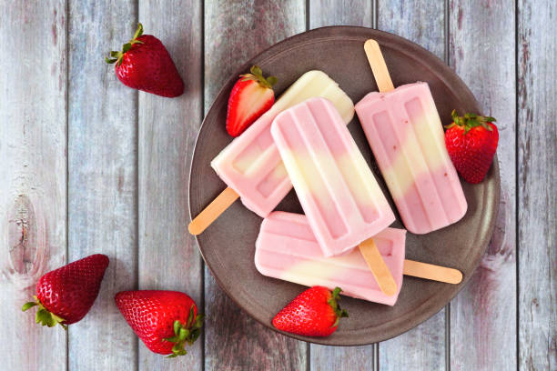 istock Healthy summer strawberry yogurt popsicles, above view over rustic wood 1149915395