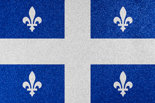 Quebec provincial flag on glitter texture.