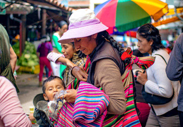 페루 원주민 어머니는 그녀가 그를 먹이 동안 그녀의 아이를 운반 - filter feeder 뉴스 사진 이미지