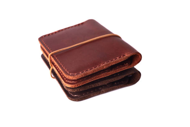 istock Handmade two red and brown leather cardholders with rubber band isolated on white background closeup. Stock photo of handmade luxury accessories. 1149920246