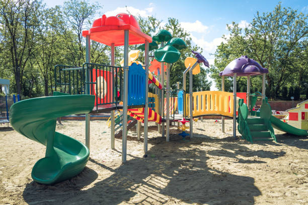 istock Children's playground on a sand surface on a sunny day. 1149920318