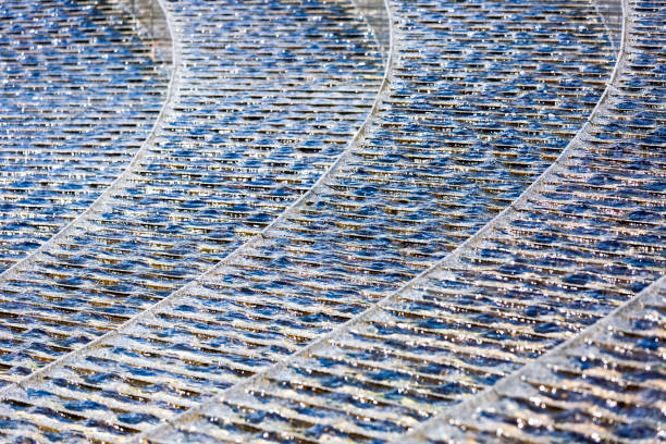 Brown concrete geometric pattern with water flowing into fountain