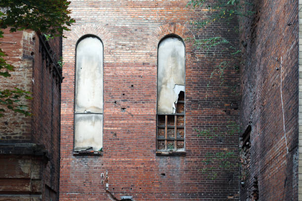 Old arched windows in a brick wall of an old destroyed building, background or concept.