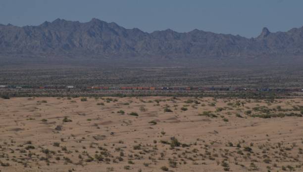 istock Train Against Mountain At Imperial Sand Dunes 1149930779