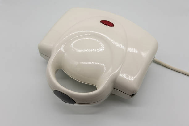 istock White grossy toaster with red light isolated on white background. 1149950099