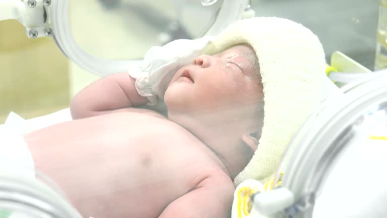 4K Portrait of young asian newborn baby boy crying inside medical intensive care units incubator at hospital, Newborn Baby inside Incubator