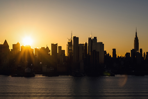 Sunrise over Midtown Manhattan on a clear day.