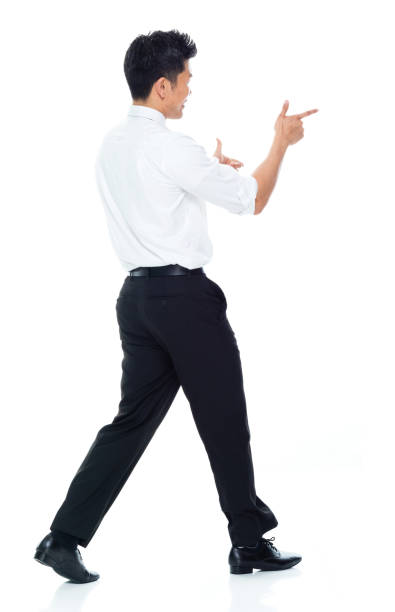istock Handsome Asian Businessman - rear view walking and doing finger gun 1149960213