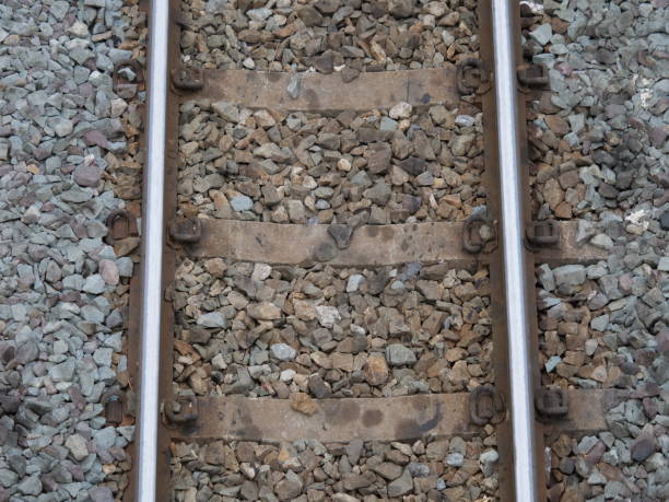 istock Top view of the train tracks with train and rock restraints in construction 1149966101